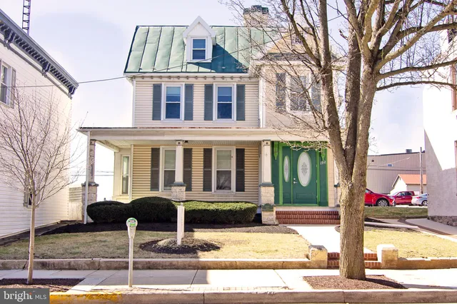 a front view of a house with street view