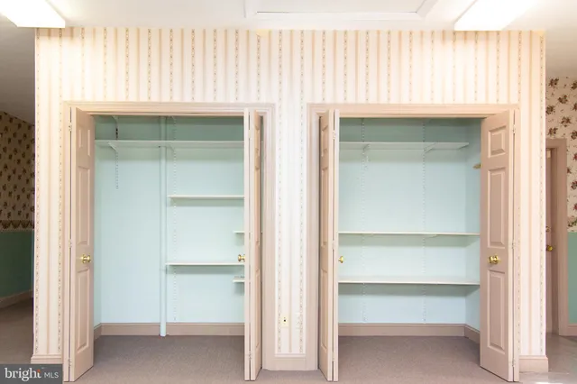 a view of a hallway with wooden floor and entryway