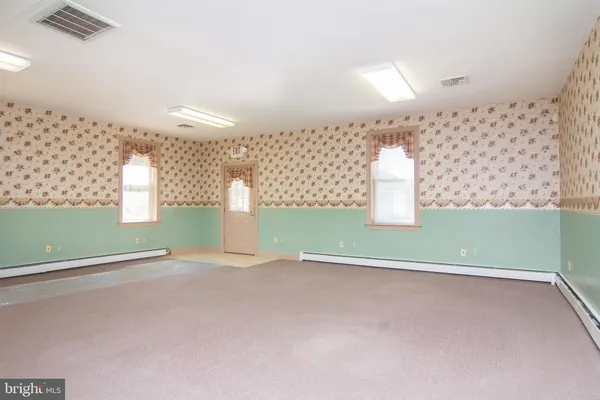 a view of a room with wooden floor
