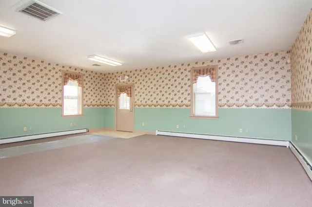 a view of a room with wooden floor