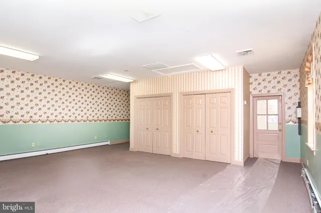 a view of a room with wooden floor & a window