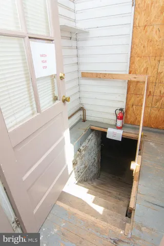 a view of a hallway with wooden floor and entryway