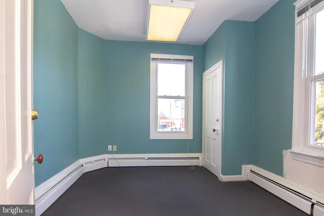 a view of a kitchen with wooden floor and iron stairs