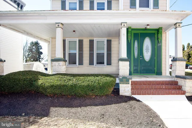 a view of an entryway with wooden floor and windows