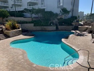 a view of a backyard with plants and outdoor seating