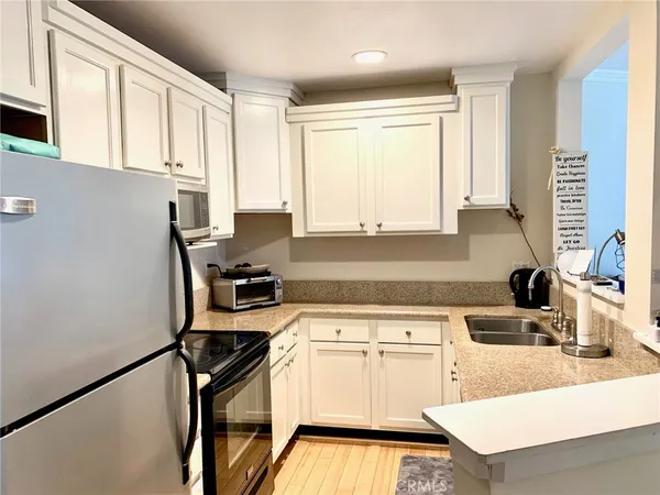 a kitchen with appliances cabinets and a sink