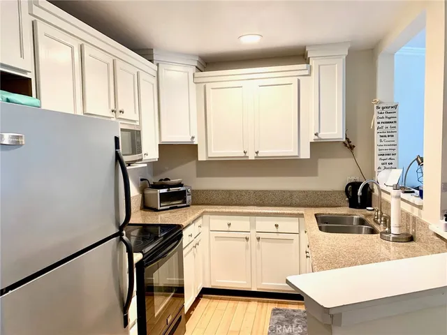 a kitchen with appliances cabinets and a sink