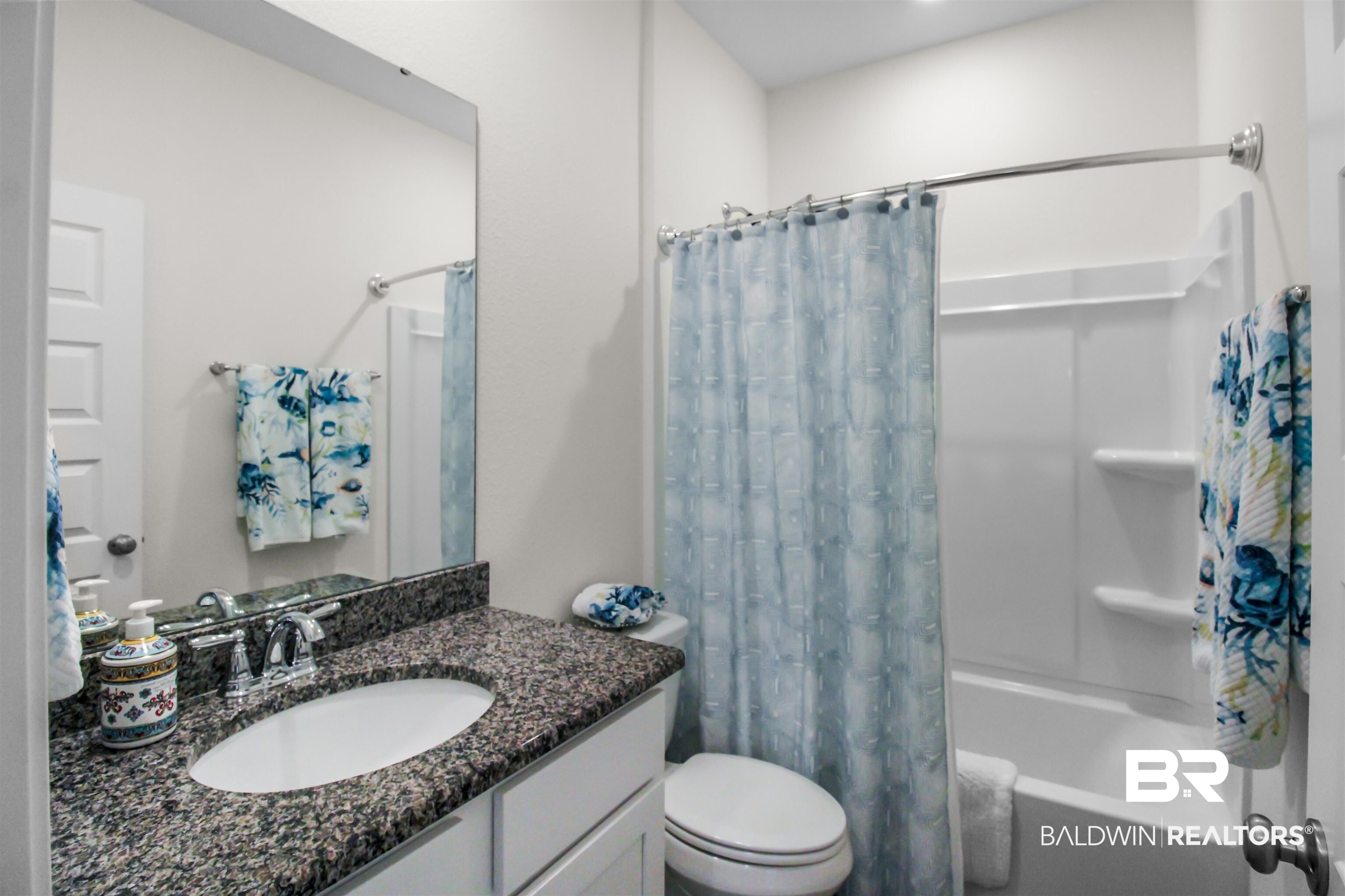 1885 Carly Street Foley, AL 36535 - Photo 25 of 40 Bathroom featuring a granite countertop vanity with an undermount sink, a white toilet, and a white shower-tub combination