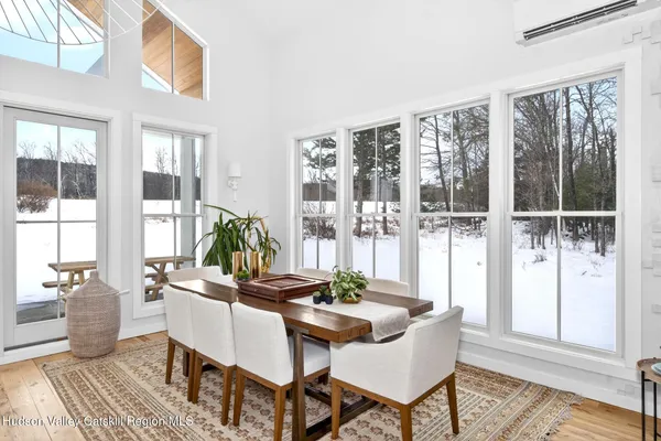 a dining room with furniture a rug and wooden floor
