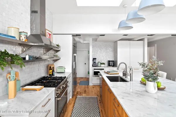 a kitchen with a stove a sink and a wooden cabinets