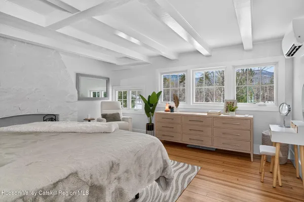 a bedroom with a bed and a large window