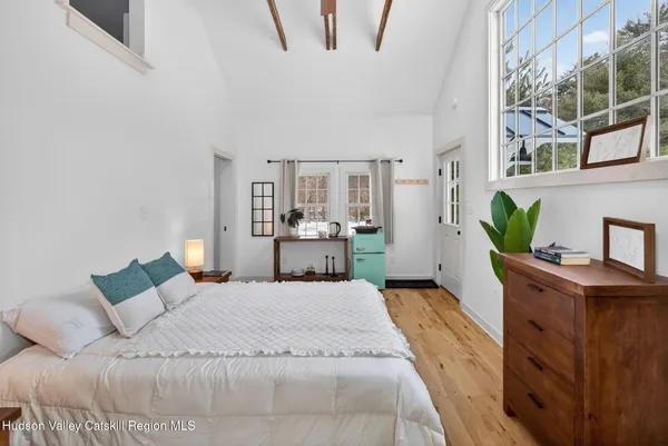 a spacious bedroom with a bed and a table