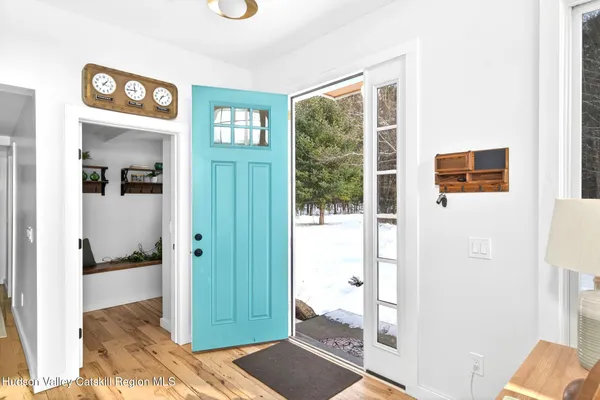 a view of a hallway with bathroom and glass door