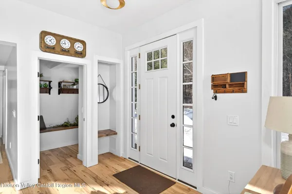 a view of a hallway with wooden floor and windows