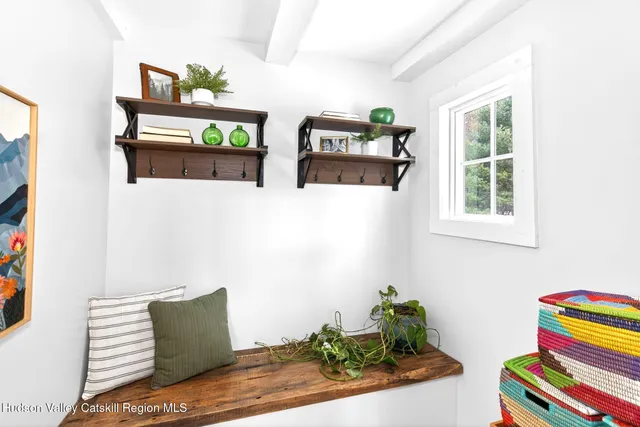 a dining room with wooden floor and white walls
