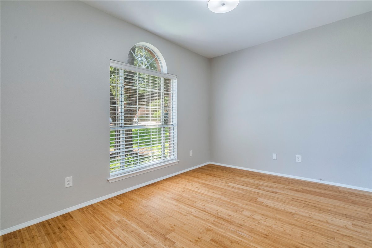 6530 Needham Lane Austin, TX 78739 - Photo 19 of 29 Bright hardwood floors and a unique arched window create an inviting atmosphere.