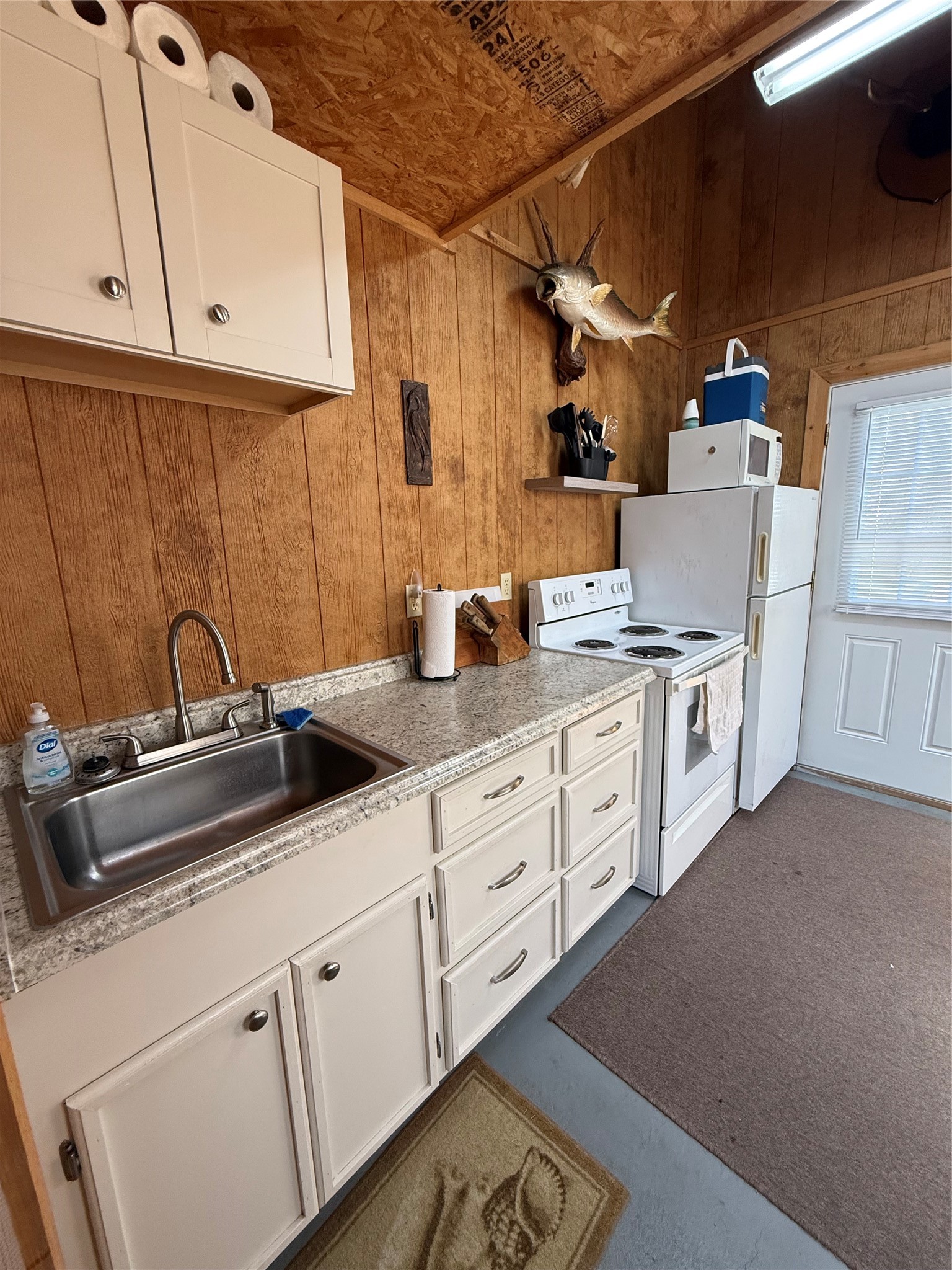 Lot 49-blk Sec 3 County Road 201 Sargent, TX 77414 - Photo 21 of 30 a kitchen with appliances a sink and cabinets