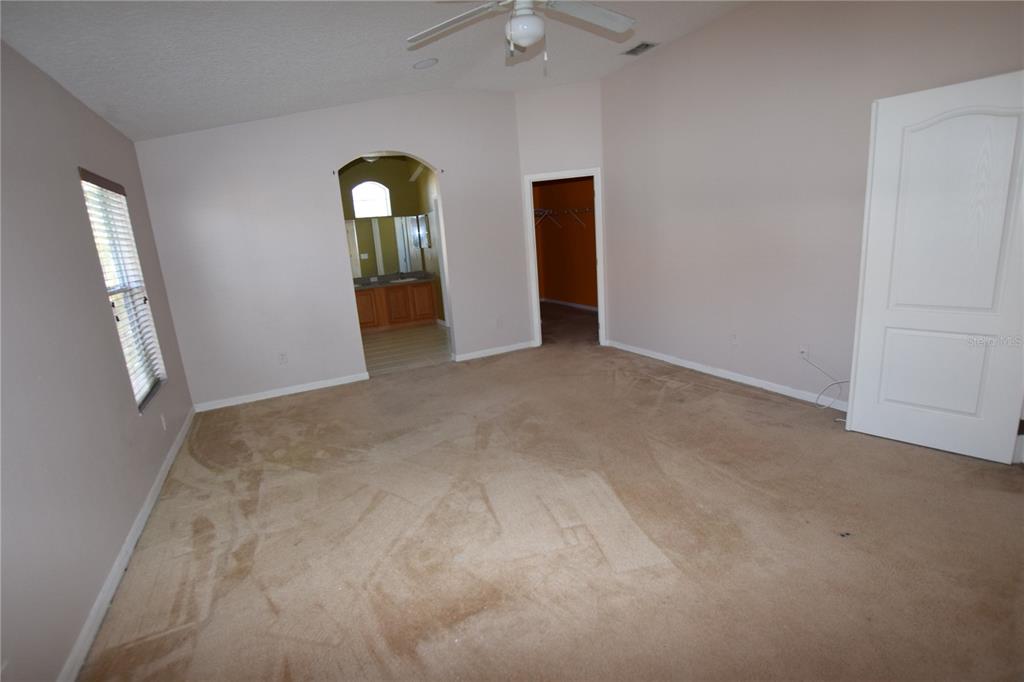 3118 Riachuelo Lane Kissimmee, FL 34744 - Photo 18 of 26 an empty room with closet and mirror