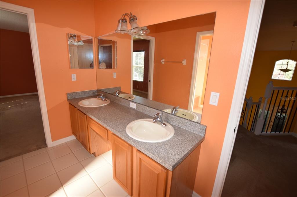 3118 Riachuelo Lane Kissimmee, FL 34744 - Photo 24 of 26 a bathroom with a sink and a mirror