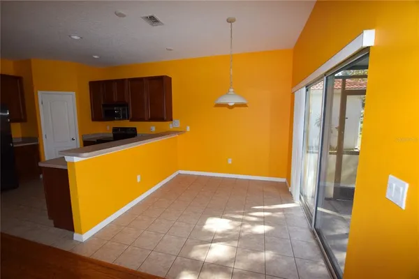 a view of a kitchen with a refrigerator and a microwave