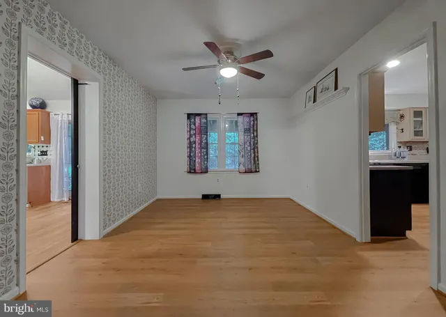 a view of a room with wooden floor and windows