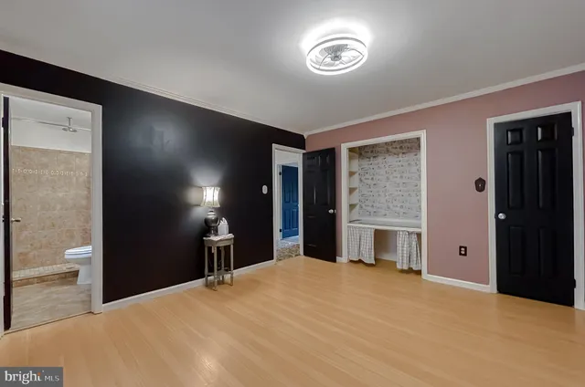 a view of a livingroom with wooden floor and a rug