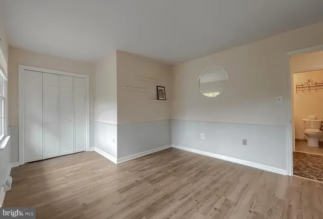 a living room with furniture kitchen view and a chandelier