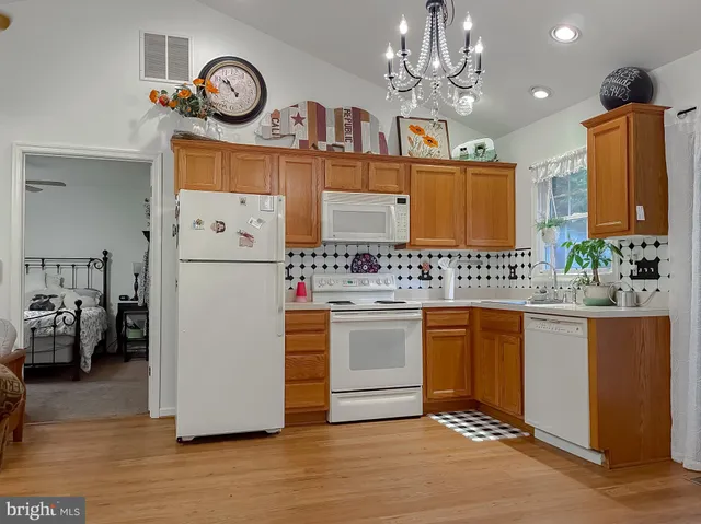 a view of a balcony with chairs and wooden floor