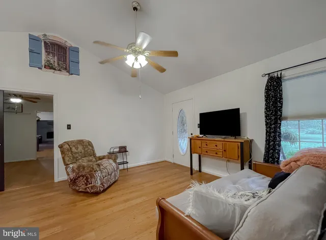 a view of a patio with table and chairs potted plants and a large tree