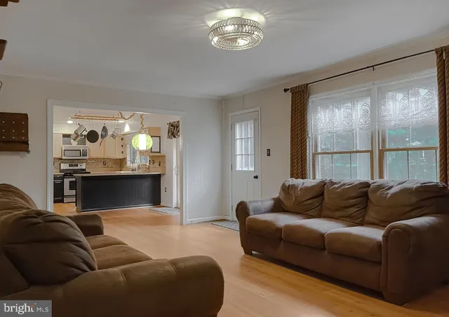 a view of a livingroom with painted walls and a window
