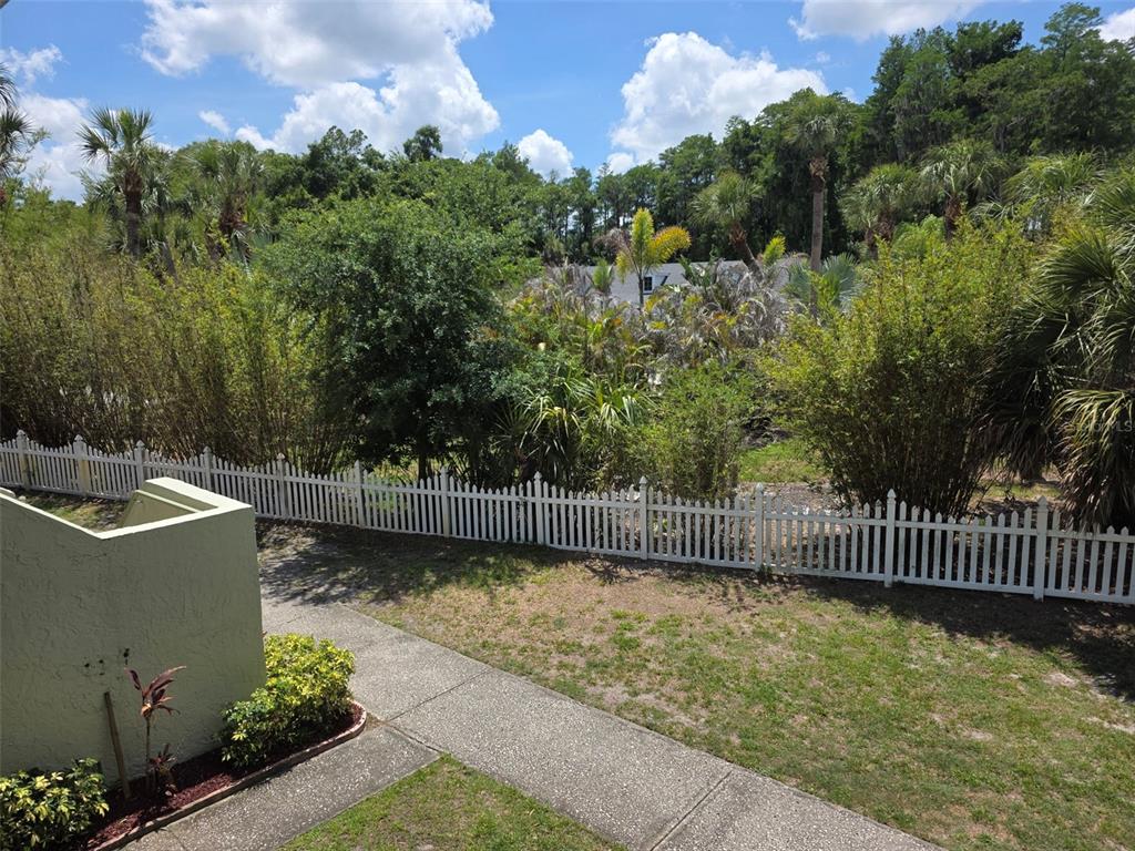 20857 Haulover Cove Road, Unit B14 Lutz, FL 33558 - Photo 26 of 35 a view of a garden with wooden fence
