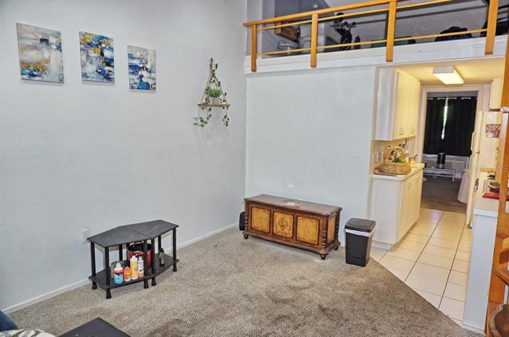 20857 Haulover Cove Road, Unit B14 Lutz, FL 33558 - Photo 3 of 35 view of room with window and furniture