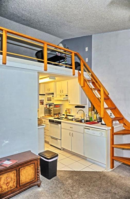 20857 Haulover Cove Road, Unit B14 Lutz, FL 33558 - Photo 7 of 35 a kitchen with a sink cabinets and appliances