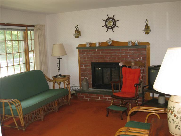 39 Russell Road Bourne, MA 02532 - Photo 3 of 22 a living room with furniture and a fireplace