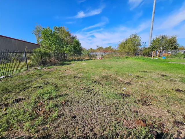a view of a field with tree in the background