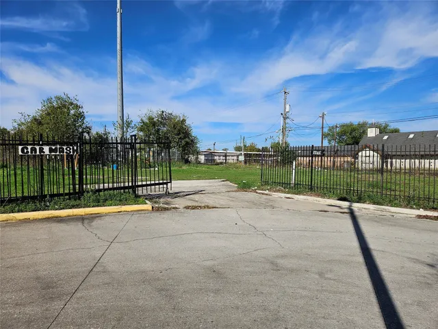 a view of a park with iron fence