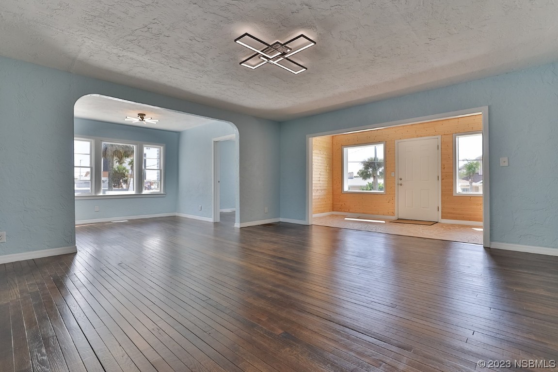 133 Milton Road Daytona Beach, FL 32118 - Photo 12 of 70 an empty room with wooden floor and windows