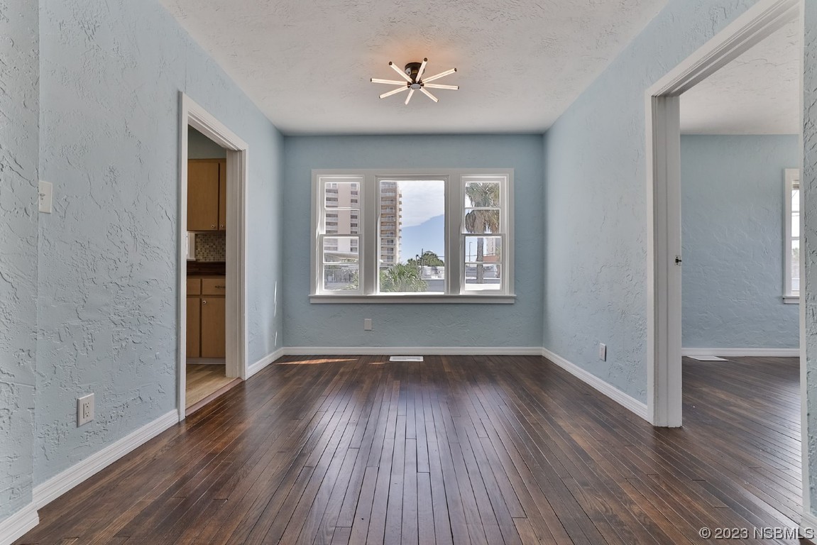 133 Milton Road Daytona Beach, FL 32118 - Photo 14 of 70 an empty room with wooden floor and windows