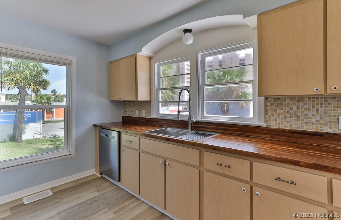133 Milton Road Daytona Beach, FL 32118 - Photo 17 of 70 a kitchen with granite countertop a window sink and cabinets