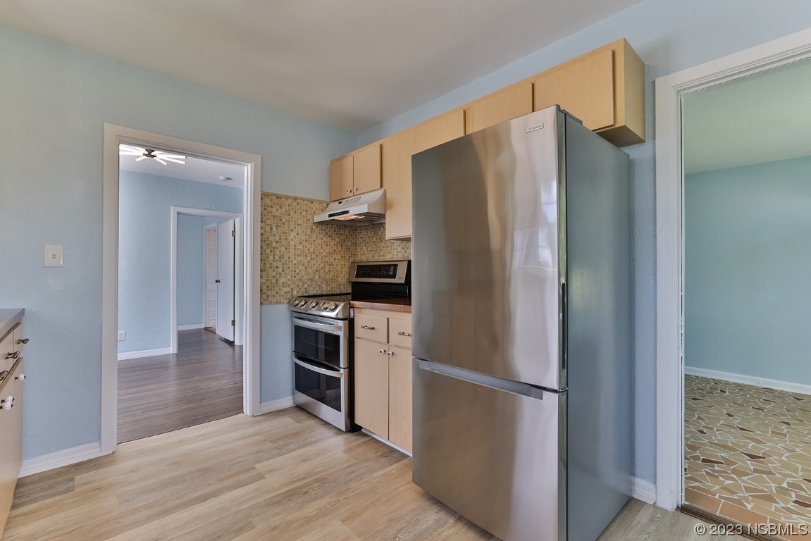 133 Milton Road Daytona Beach, FL 32118 - Photo 18 of 70 a kitchen with stainless steel appliances a refrigerator and a stove top oven