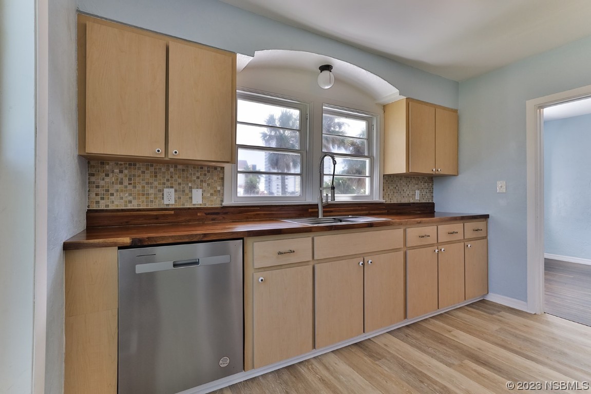 133 Milton Road Daytona Beach, FL 32118 - Photo 20 of 70 a kitchen with stainless steel appliances granite countertop a sink a stove cabinets and a window