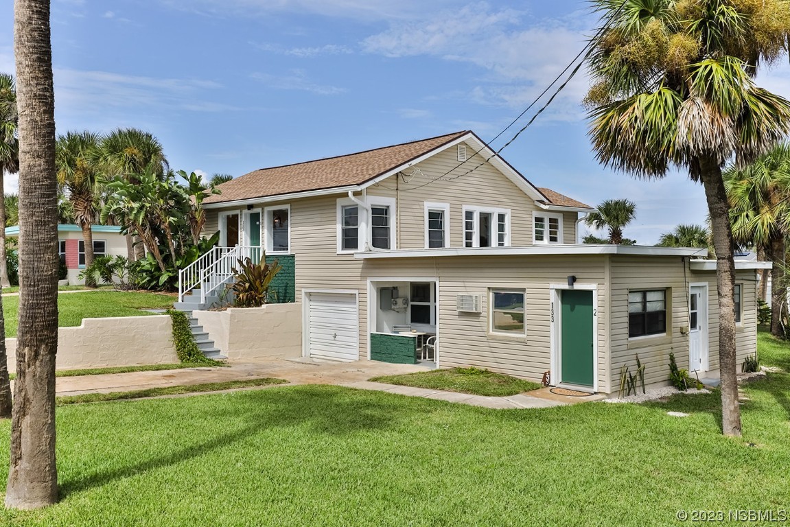 133 Milton Road Daytona Beach, FL 32118 - Photo 2 of 70 a front view of a house with a garden and yard