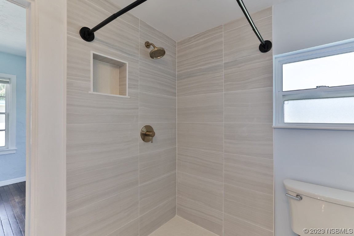 133 Milton Road Daytona Beach, FL 32118 - Photo 26 of 70 a bathroom with a shower and toilet