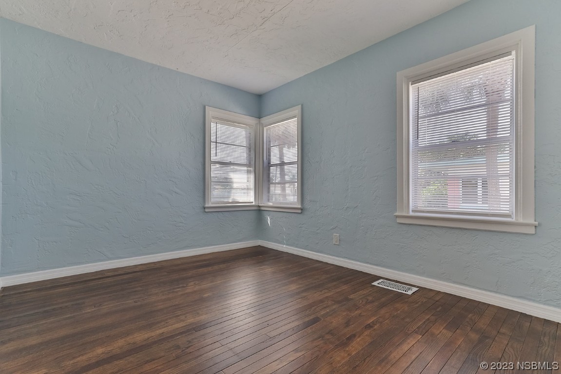 133 Milton Road Daytona Beach, FL 32118 - Photo 27 of 70 a view of an empty room with wooden floor and a window