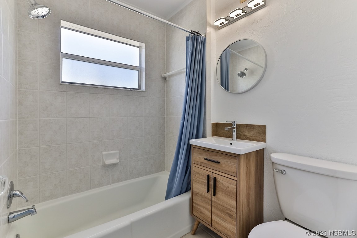 133 Milton Road Daytona Beach, FL 32118 - Photo 29 of 70 a bathroom with a toilet sink and mirror