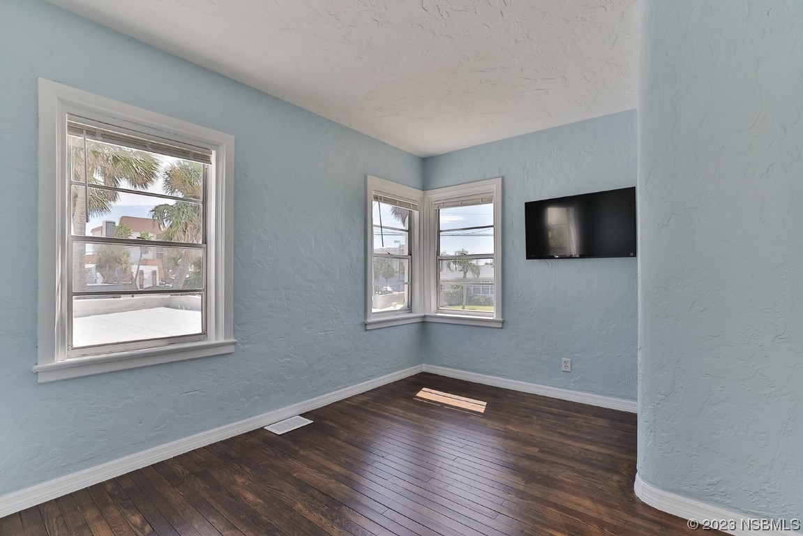 133 Milton Road Daytona Beach, FL 32118 - Photo 30 of 70 a view of an empty room with wooden floor and a window