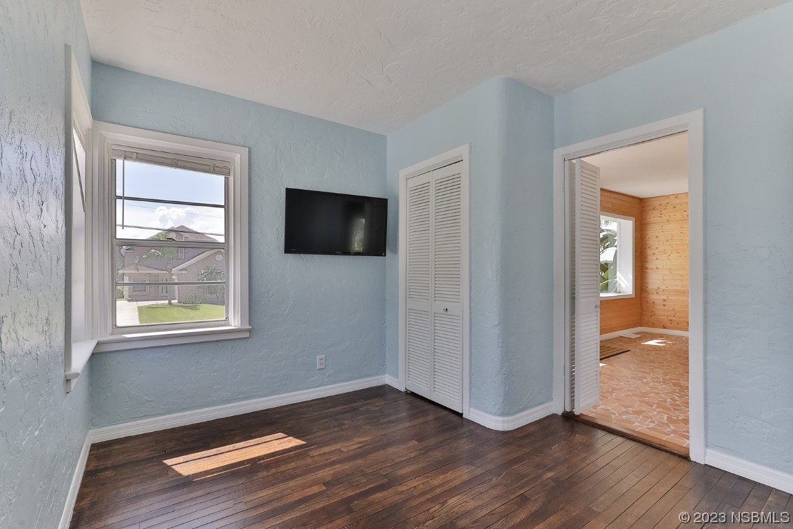 133 Milton Road Daytona Beach, FL 32118 - Photo 31 of 70 an empty room with wooden floor and windows