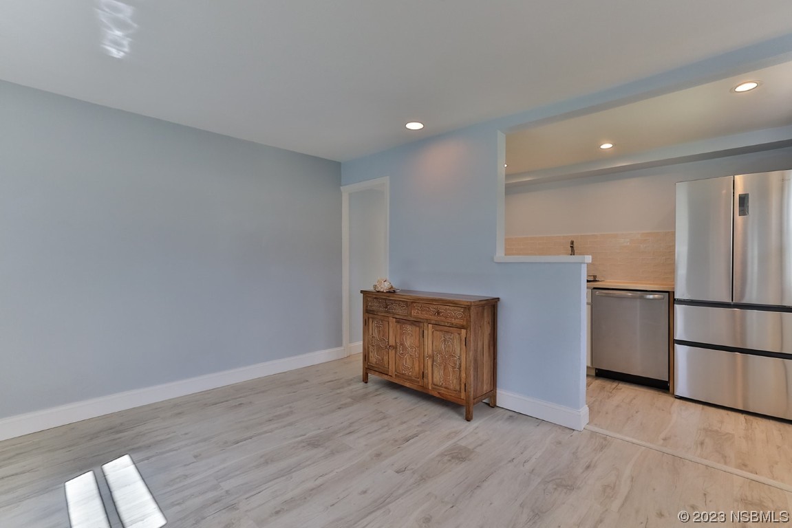133 Milton Road Daytona Beach, FL 32118 - Photo 37 of 70 a view of kitchen with refrigerator and wooden floor