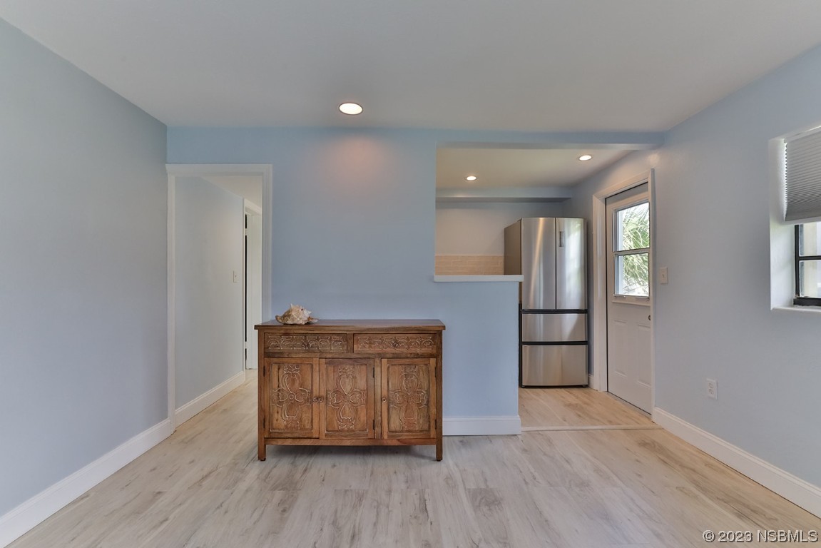 133 Milton Road Daytona Beach, FL 32118 - Photo 38 of 70 an empty room with wooden floor and cabinet