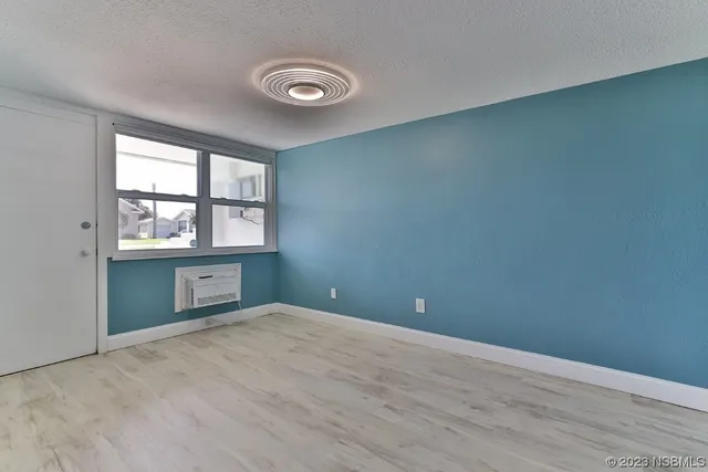an aerial view of a house with swimming pool and outdoor seating